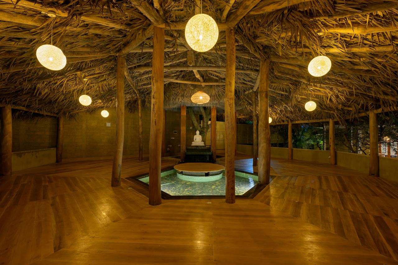 Open yoga pavilion immersed in greenery