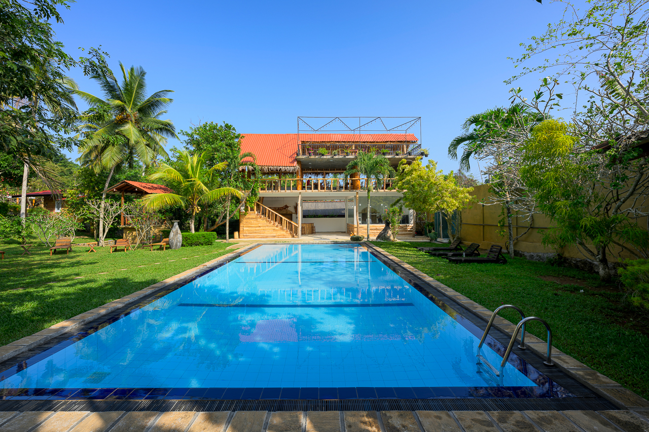 Resort exterior with pool and garden.