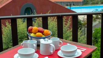 Breakfast setting with view to the swimming pool, self-catering apartment cottage, Quinta das Vinhas vineyard, Madeira