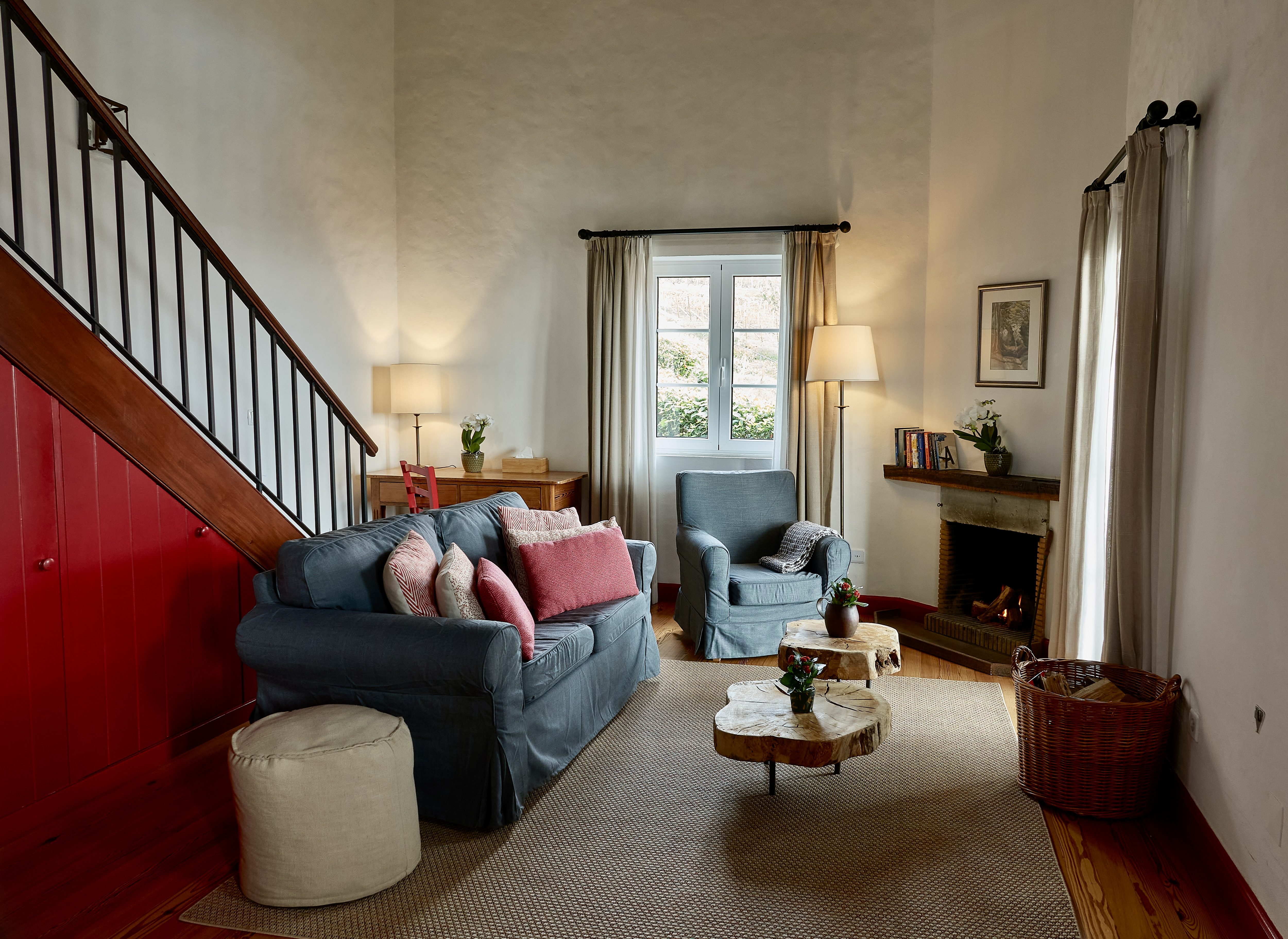 Sitting room with fireplace in Mezanine Cottage Suite at Quinta das Vinhas.