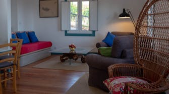 Sitting room in cottage, sculptural coffee table in wood and glass, Quinta das Vinhas vineyard self-catering accommodation