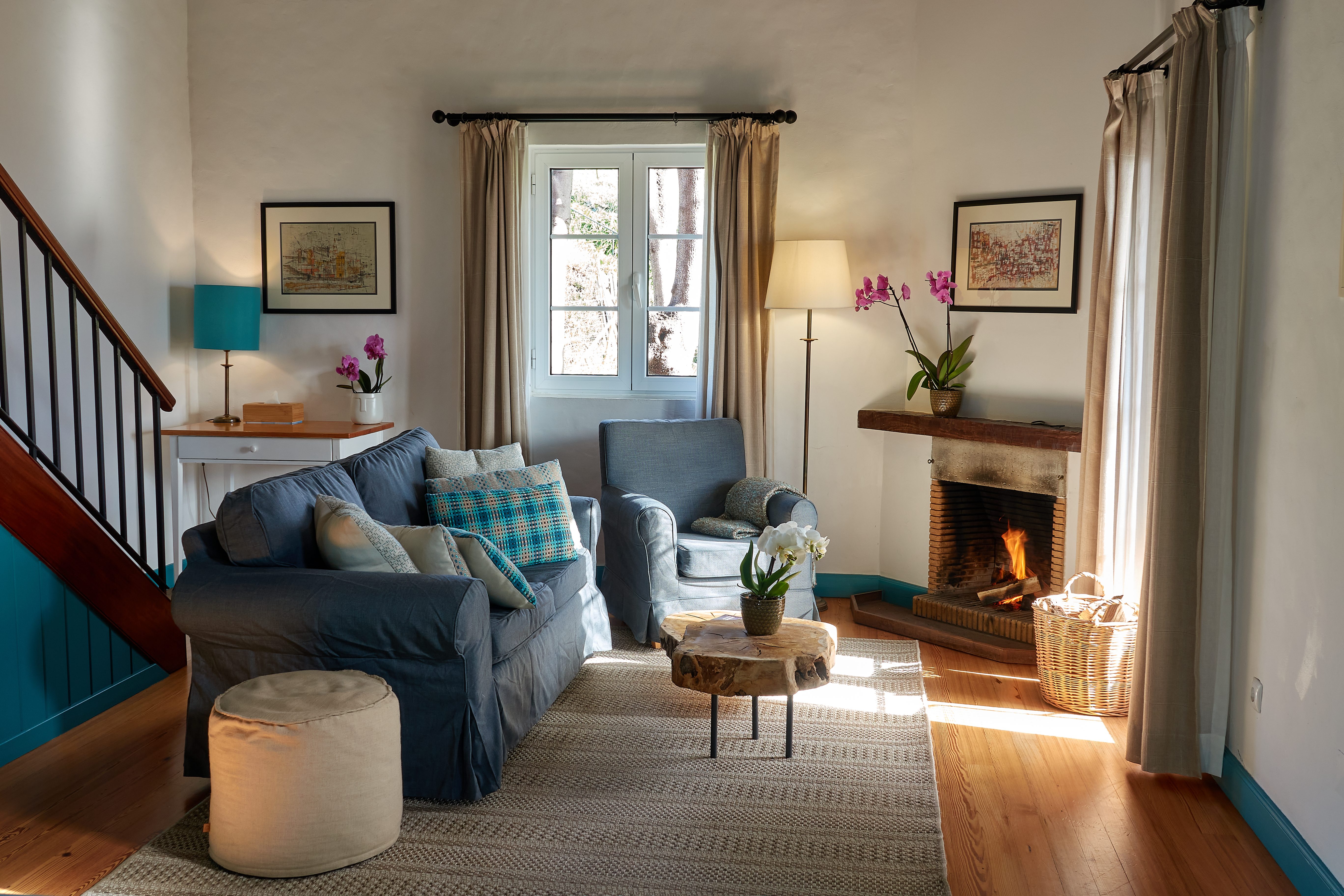 Sitting room with fireplace in Mezanine Cottage Suite at Quinta das Vinhas.