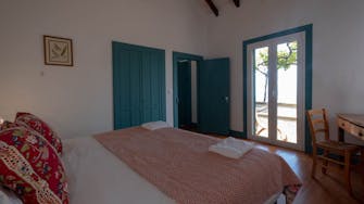 Bedroom in secluded area of vineyard at Quinta das Vinhas self-catering suites, with doors to the terrace, Madeira island