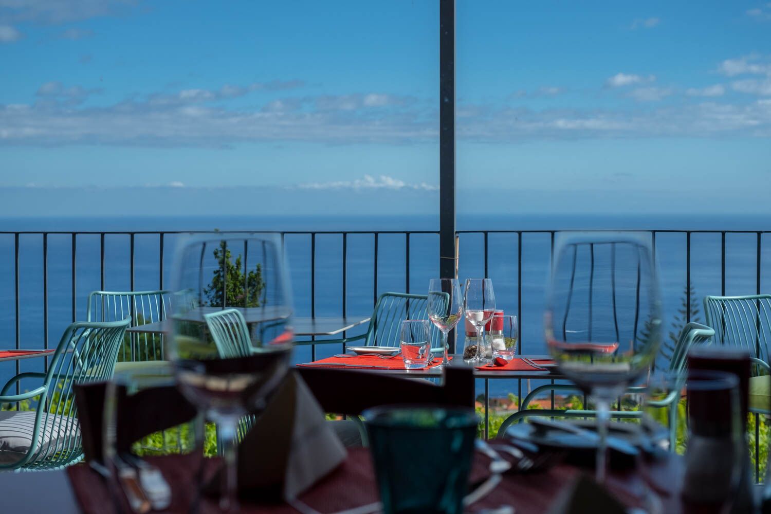 Table setting at our wine bar restaurant with views over the vineyard to the blue sea beyond,