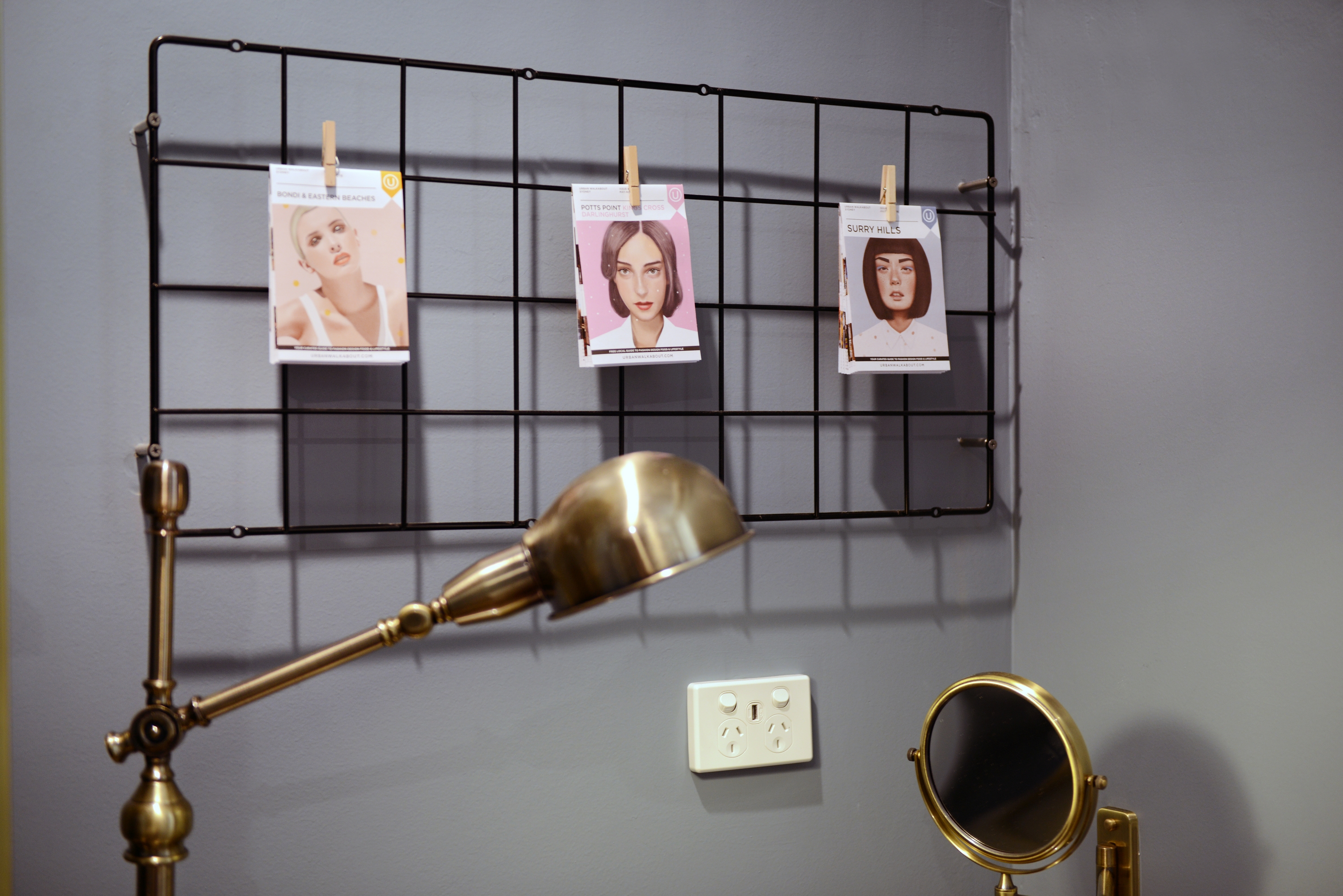 Artistic desk light and photo display above outlet