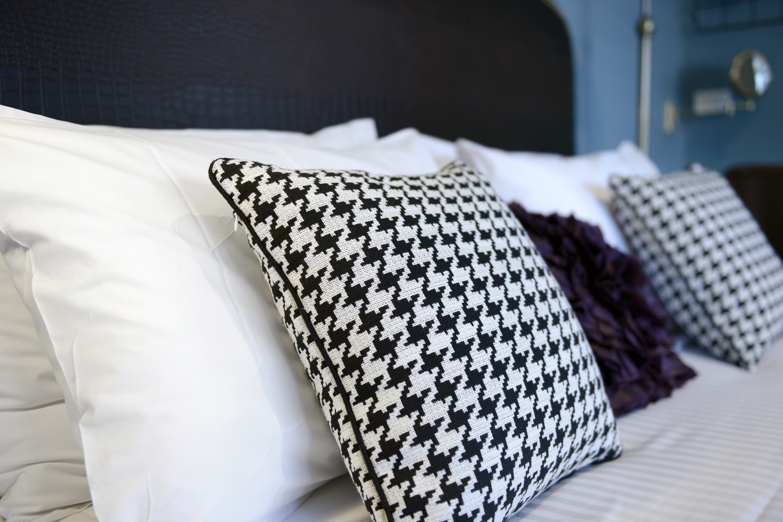 Close-up of patterned cushion on king bed