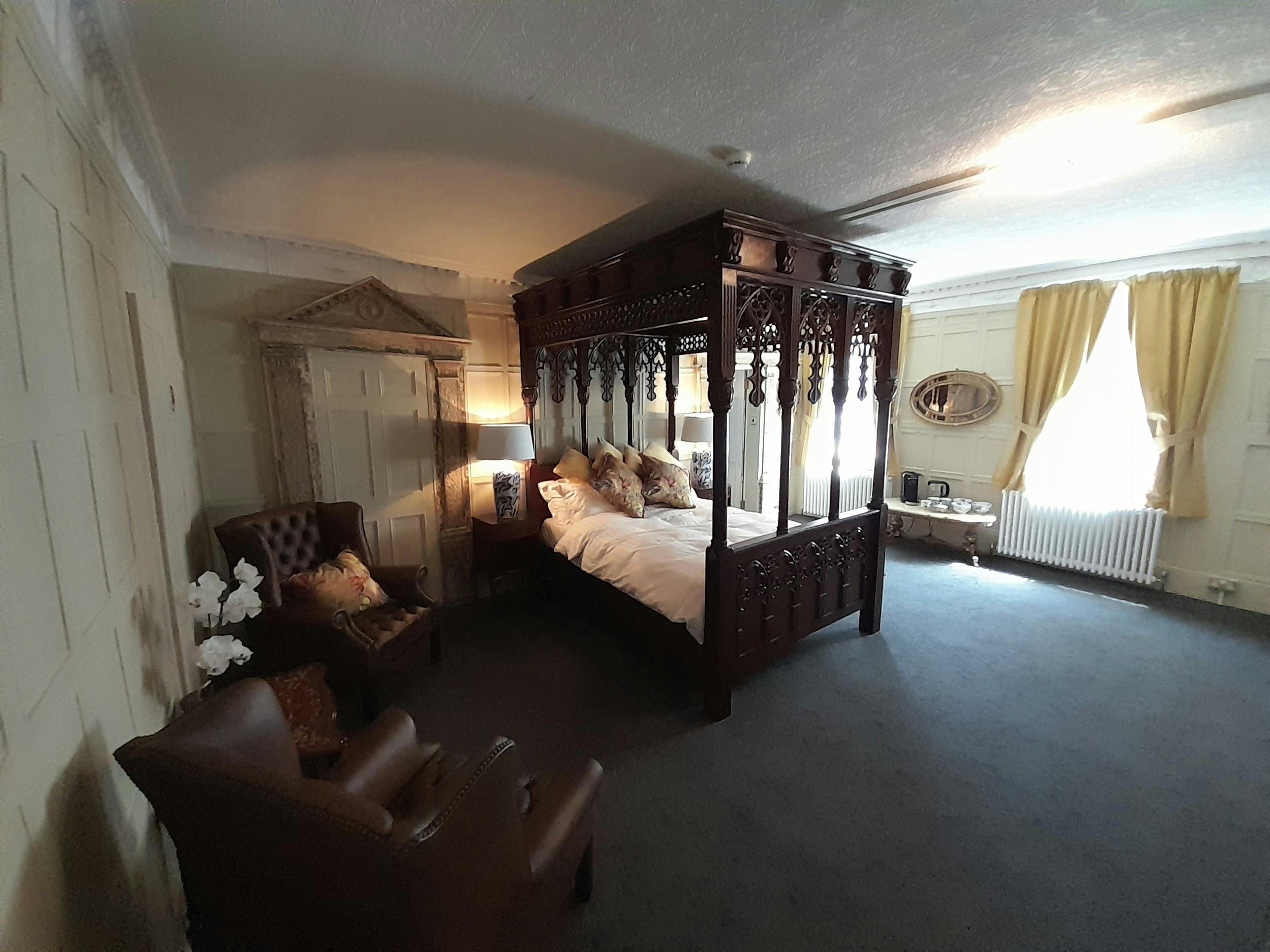 Hand carved four poster bed to the Judge Huddlestone suite