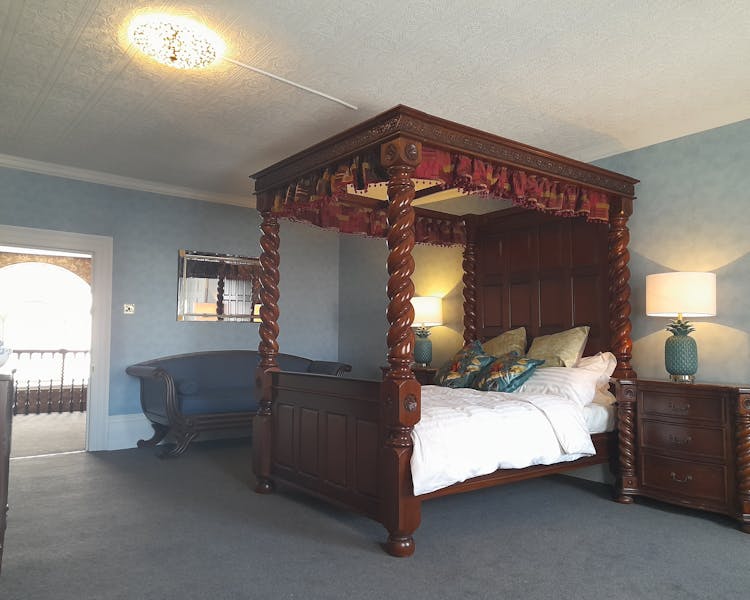 Hand carved four poster bed in Judge Melish bedroom