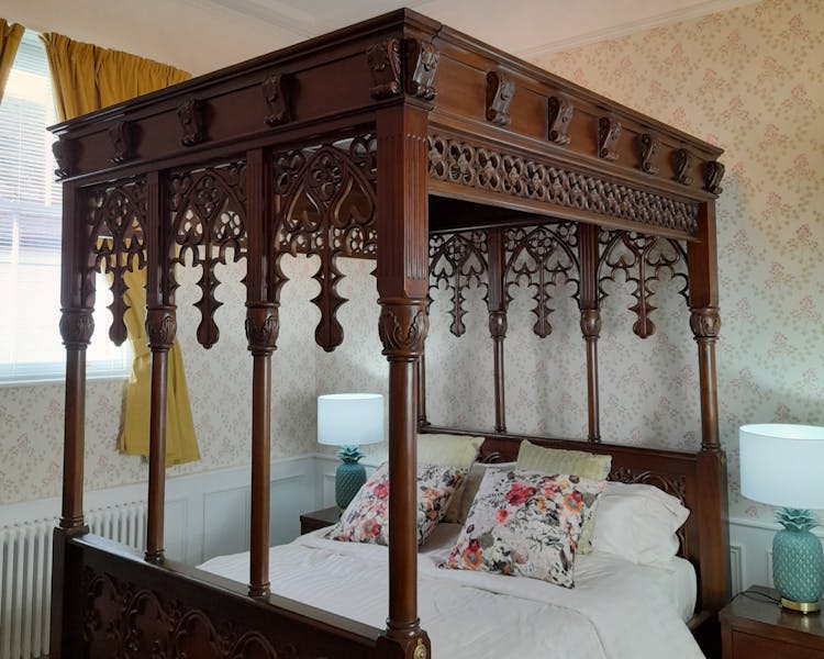 Hand carved four poster bed in the Judge Wright suite