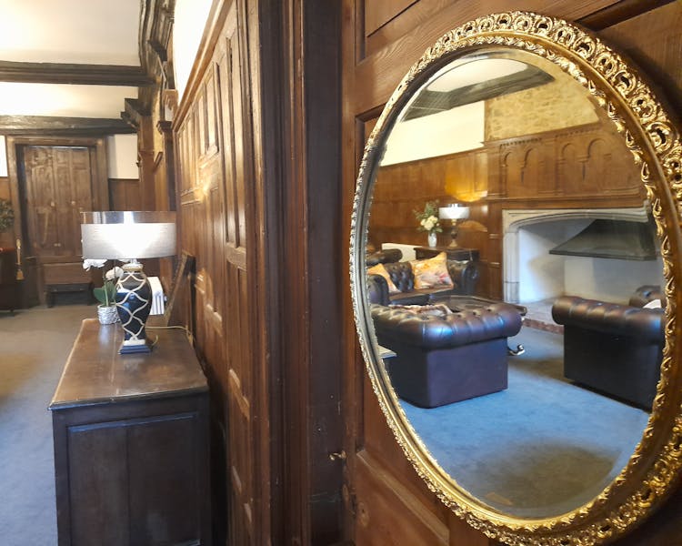 Antique mirror in oak panelled living room
