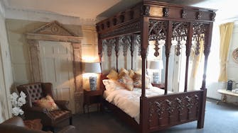 Hand carved four poster bed in Judge Huddlestone bedroom