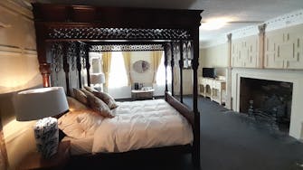 Hand carved four poster bed to the Judge Huddlestone suite