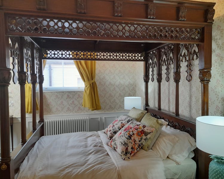 Hand carved four poster bed in the Judge Wright suite