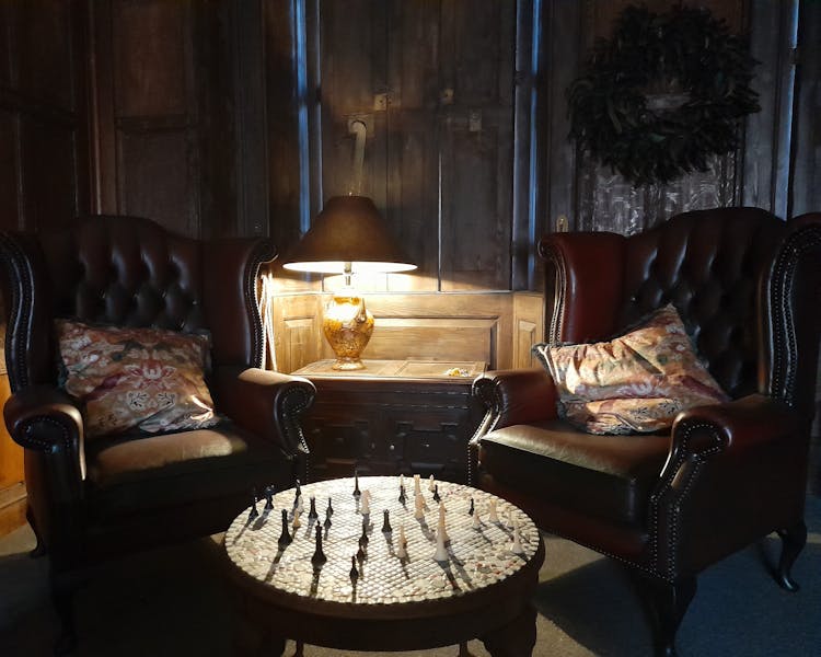 Leather Chesterfield armchairs with chessboard