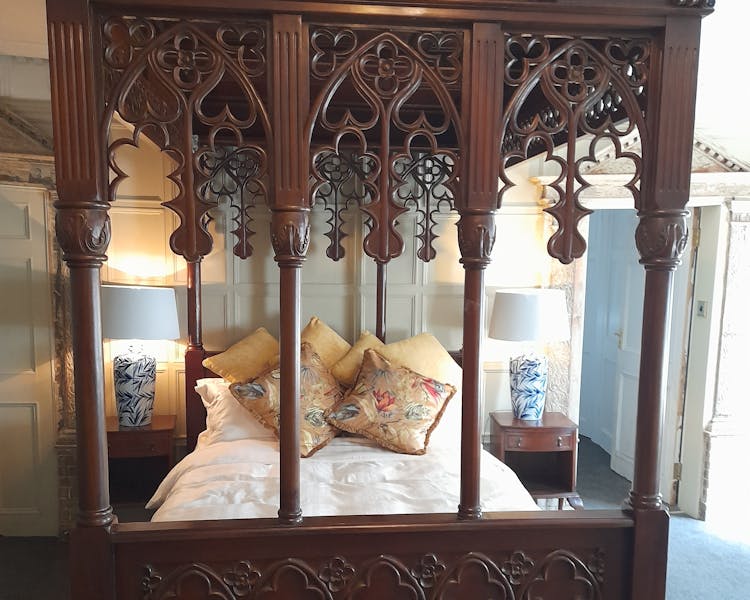 Hand carved four poster bed in Judge Huddlestone bedroom