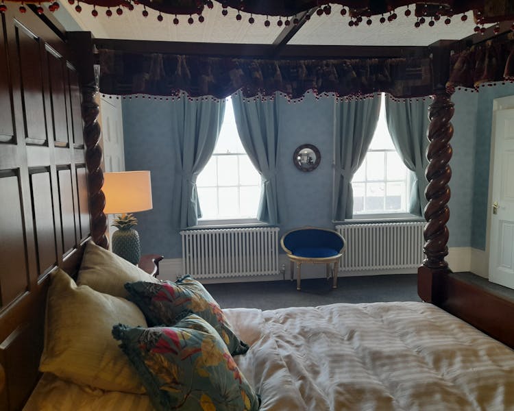 Hand carved four poster bed in Judge Melish bedroom