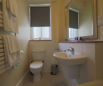 Bathroom with toilet and sink. Towels on a towel rail. Clean and fresh. Royal Hotel, Stornoway, Isle of Lewis