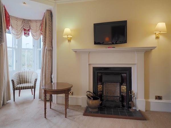 Deluxe harbour view room with fireplace and seating area in the Royal Hotel, Stornoway on the Isle of Lewis
