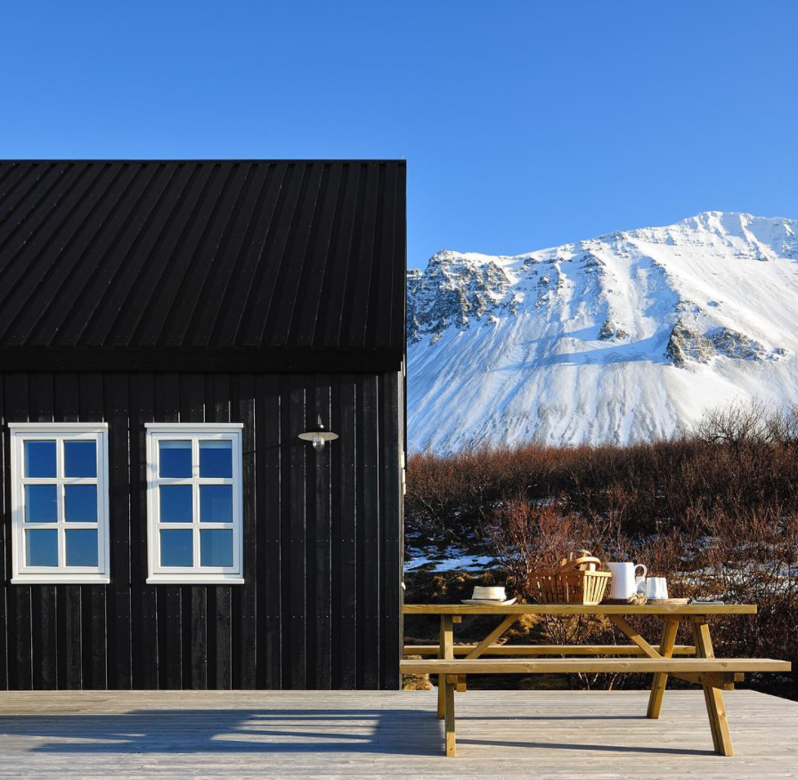 The Black house near Borgarnes and Mt. Hafnarfjall.