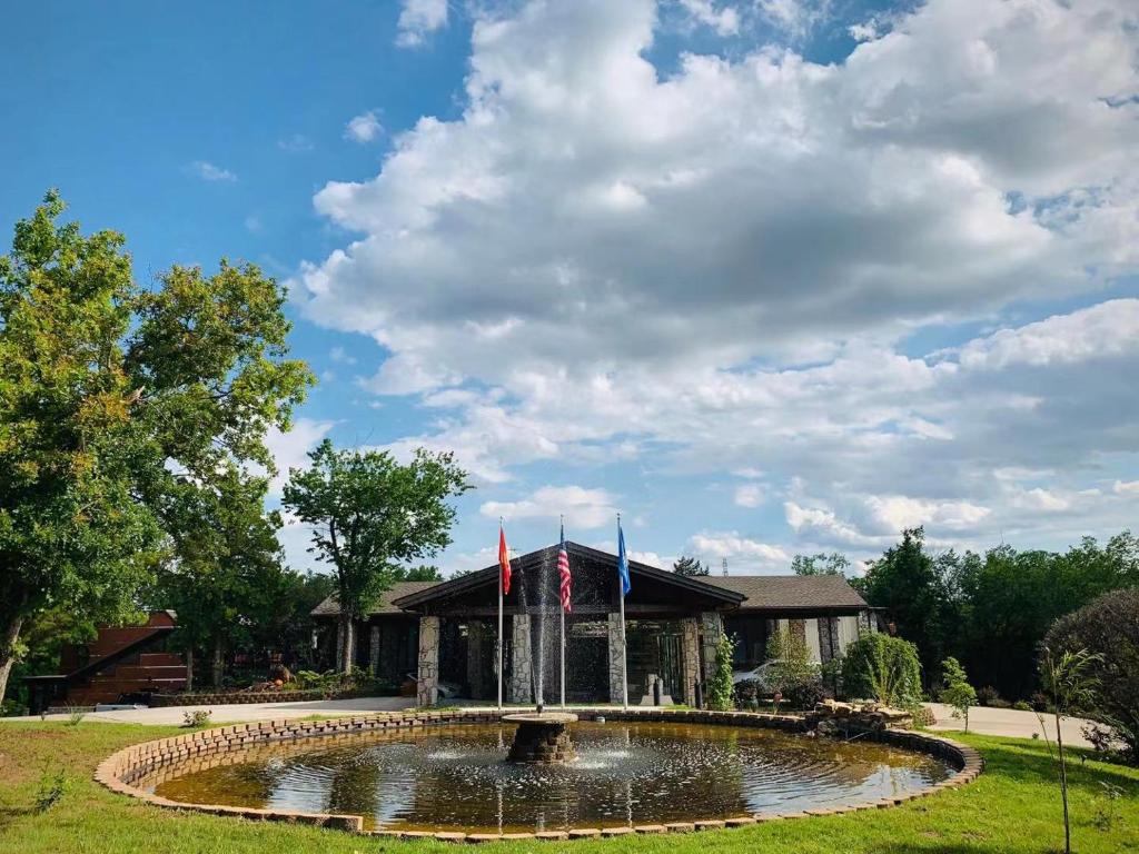 Front fountain and entrance view of WangShi Palace surrounded by greenery