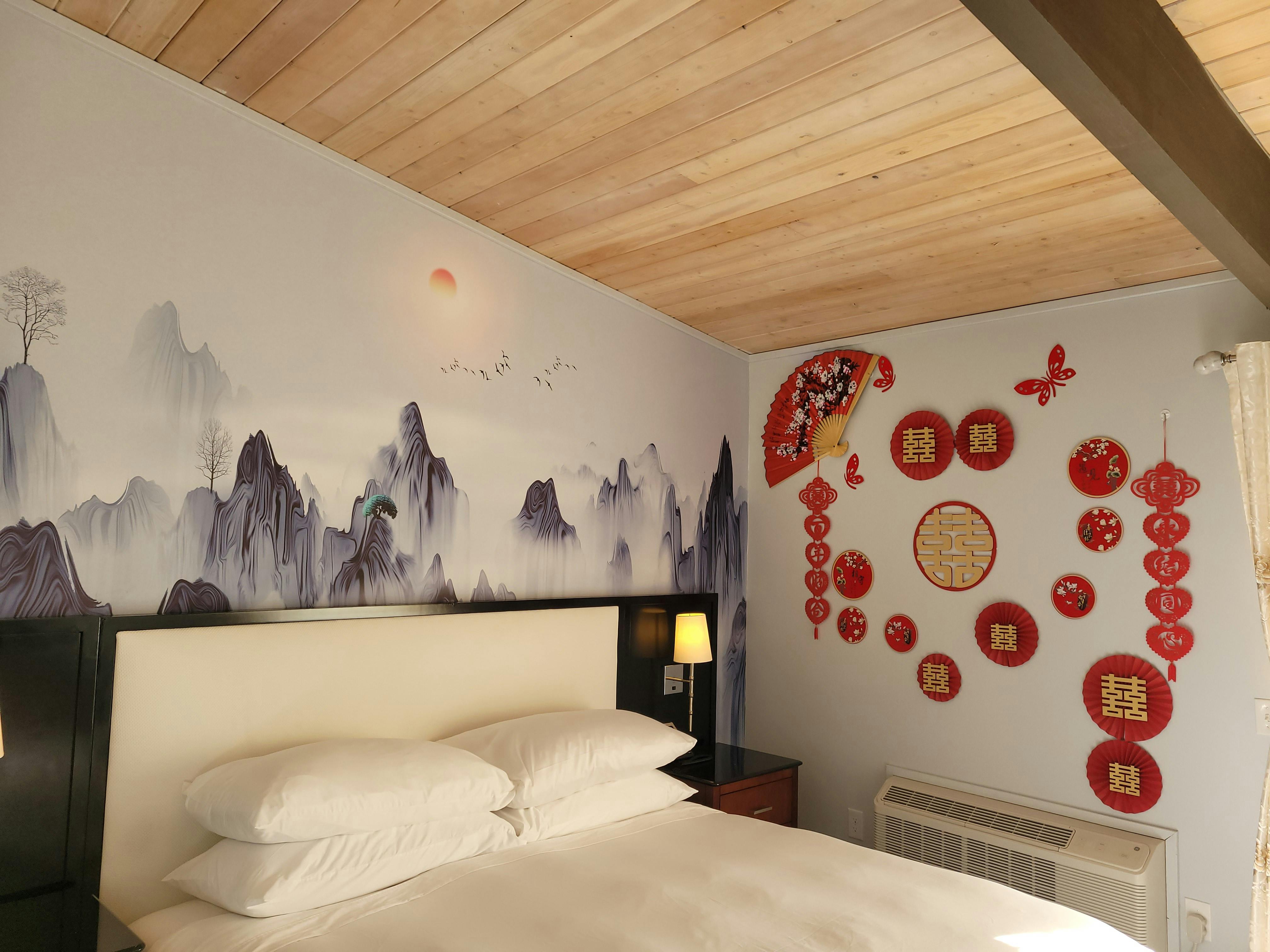 Romantic Chinese wedding-themed wall art in the Honeymoon Room at WangShi Palace — elegant and festive décor.