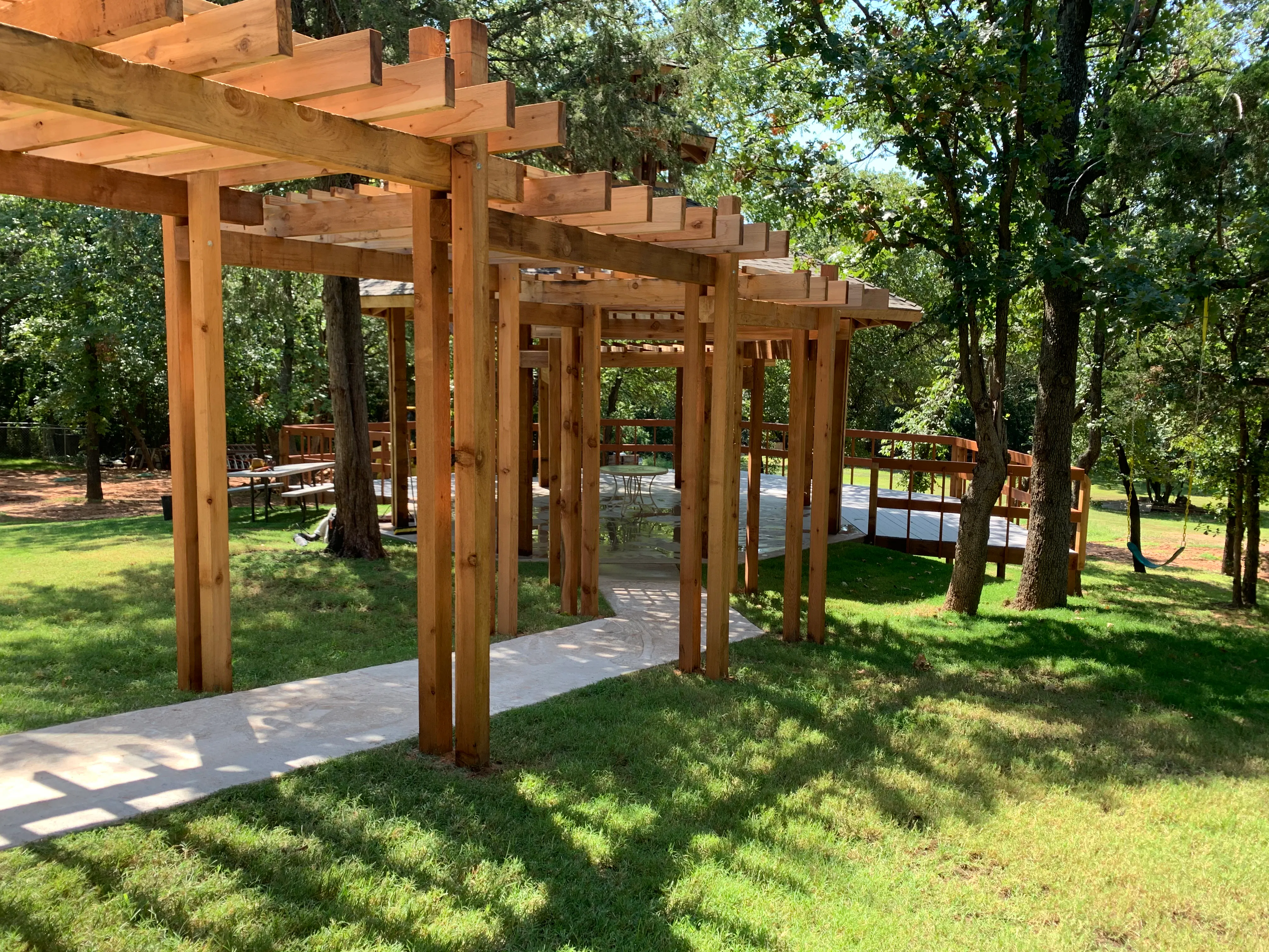 Wooden garden pergola walkway leading to the event pavilion