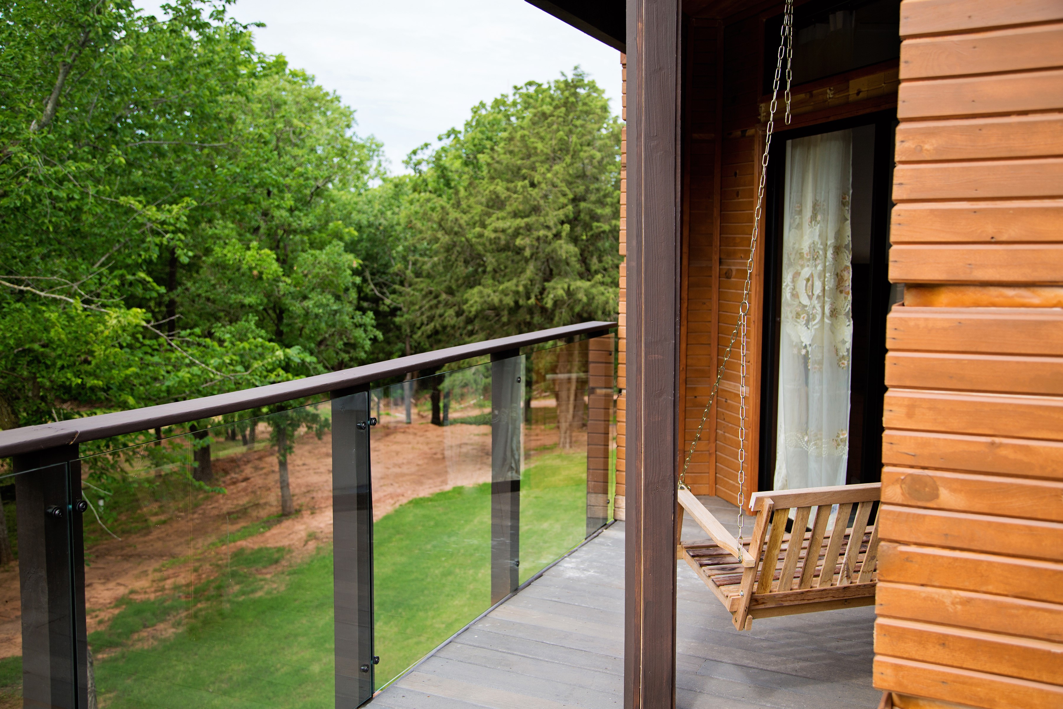 Outdoor fire pit seating with lush green forest backdrop