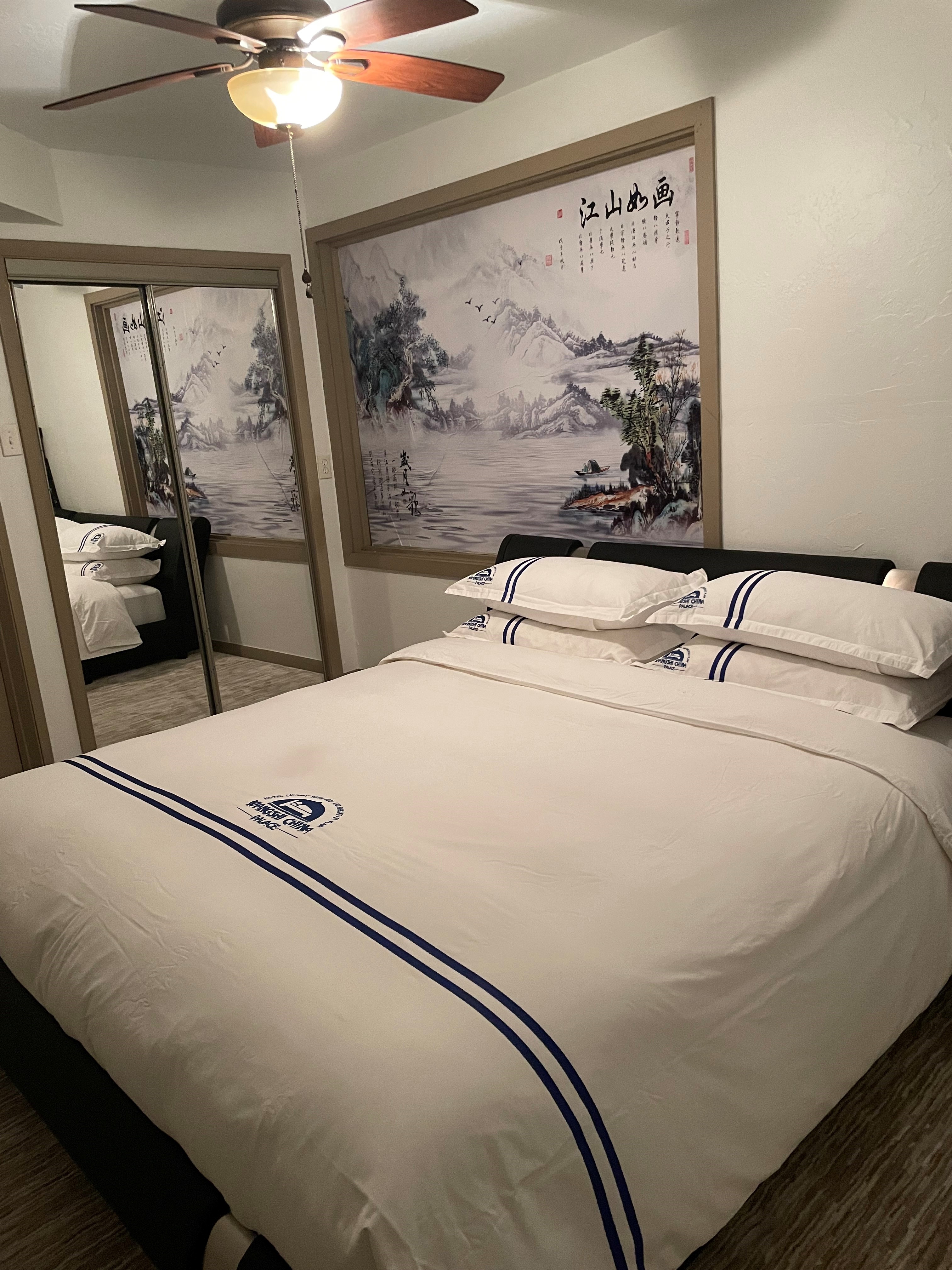 Standard Suite Type 11 master bedroom at WangShi Palace — comfortable king bed with Chinese landscape art