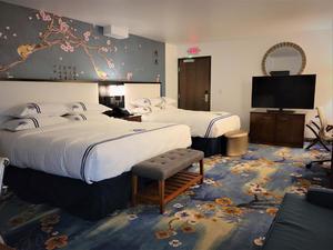 Spacious room with one king bed and one XL bed, featuring a massage bathtub and separate shower – Wang Shi China Palace OKC