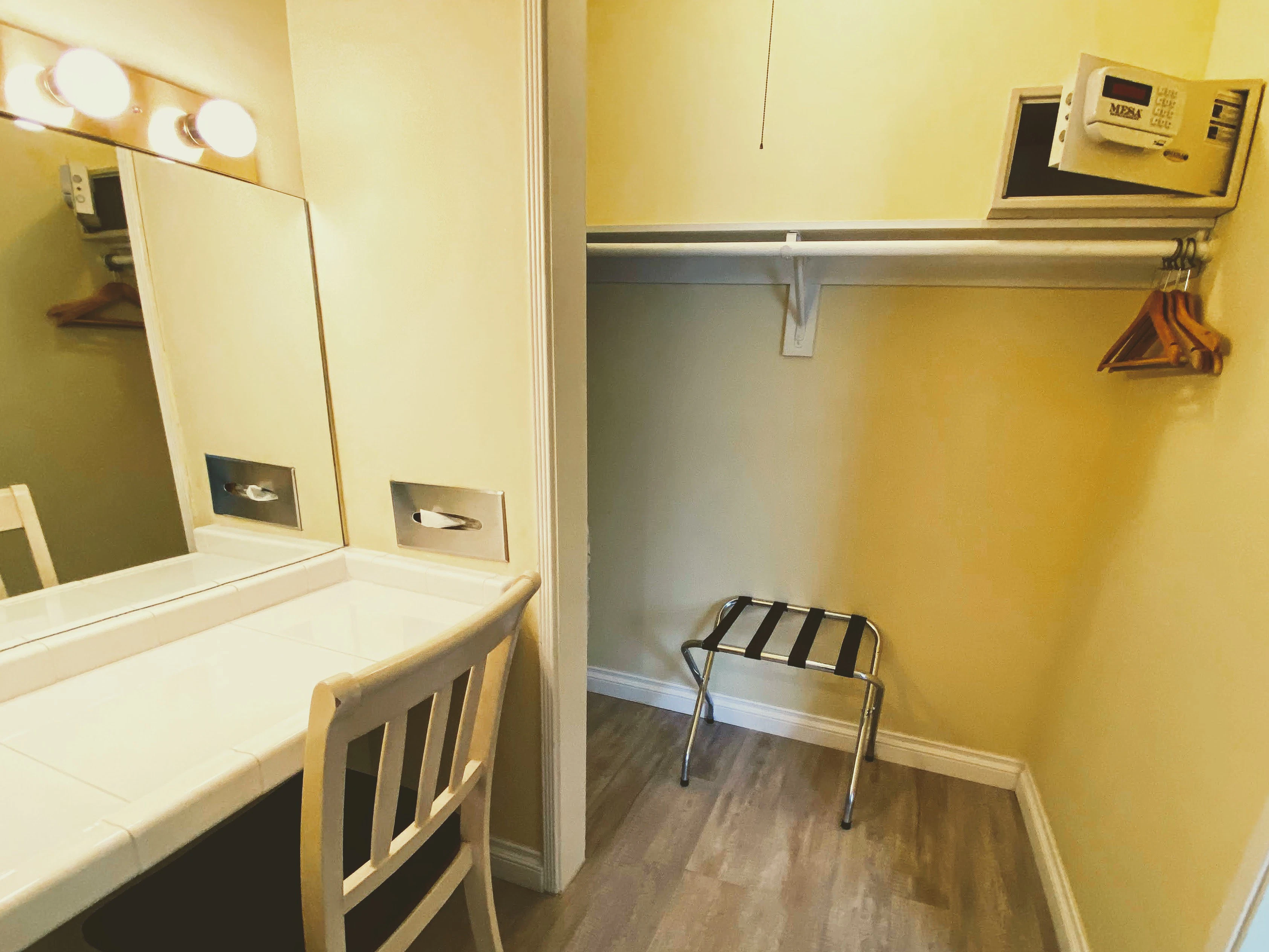 A hotel room closet and vanity area