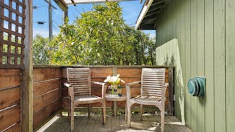 Upper Tree Teak Deck chairs and flowers with landscaping in background